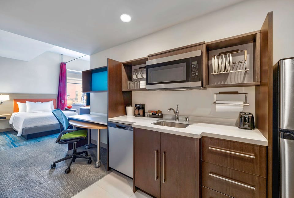 Desk, laptop workspace, iron/ironing board, bed sheets