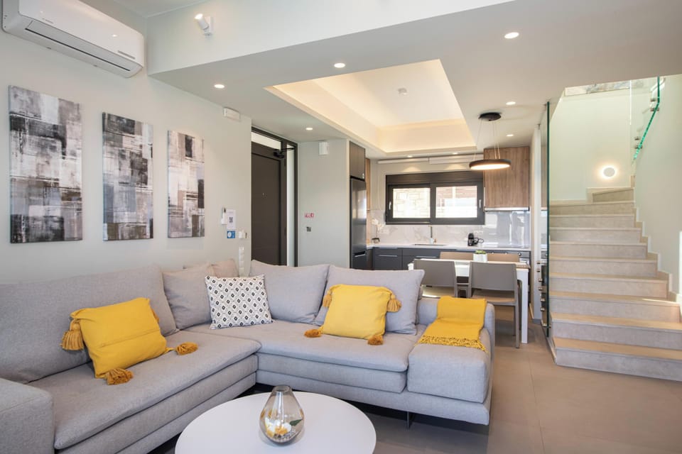 Air-conditioned living room features a large corner sofa and 55" HDTV