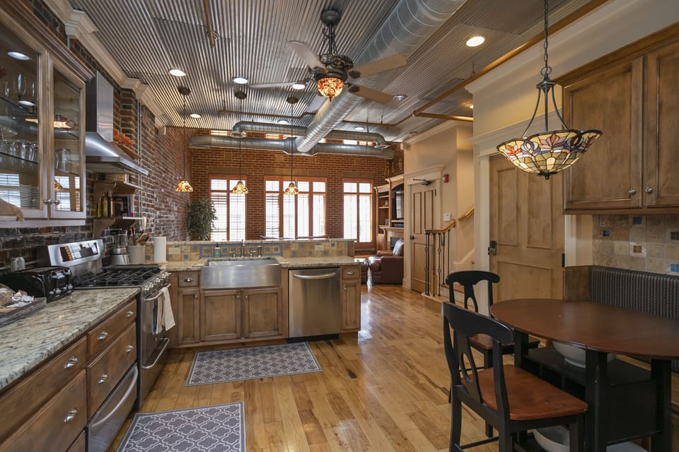 - Nashville brick-accent kitchen with stainless appliances and warm wood cabinets   - Open layout connects dining and living for easy group gatherings   - Bright natural light creates a welcoming space for cooking and meals