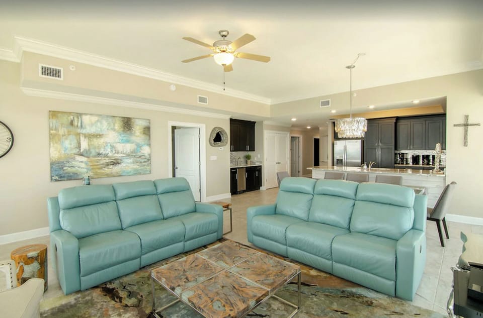 Living Room, Penthouse, Kitchen, Ceiling Fan, Couches, Chandelier, Art, Tile. 