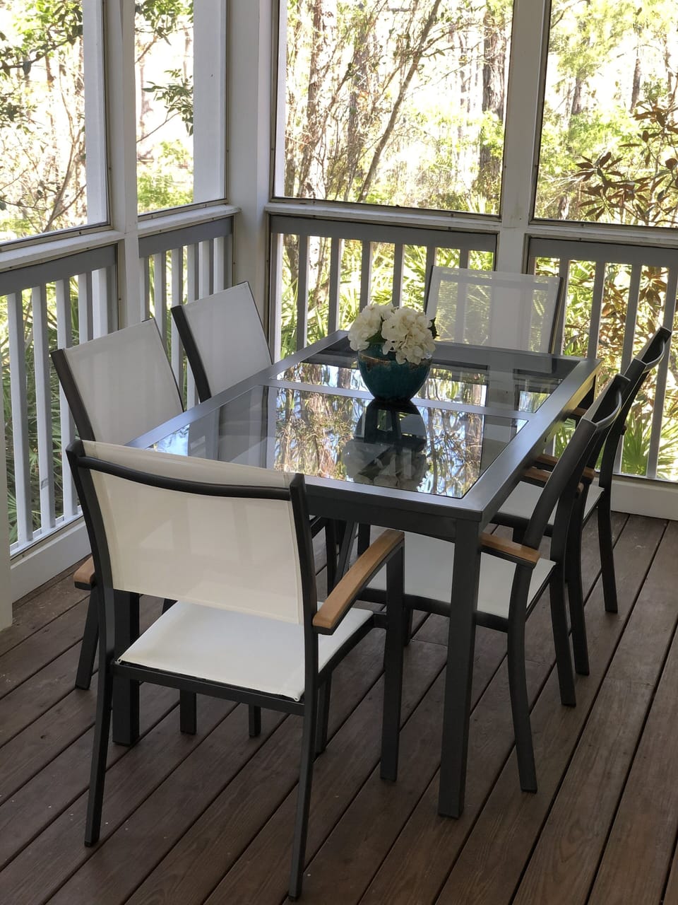Outdoor dining in the screened porch off the living room.
