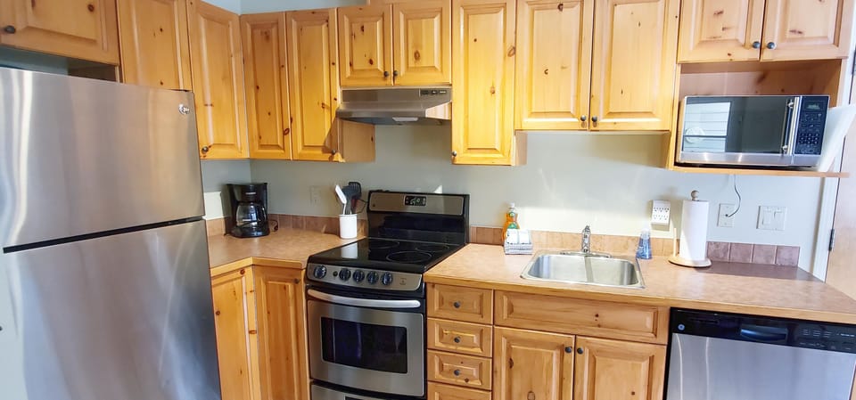 Kitchen is equipped with modern appliances and all the cooking tools you need