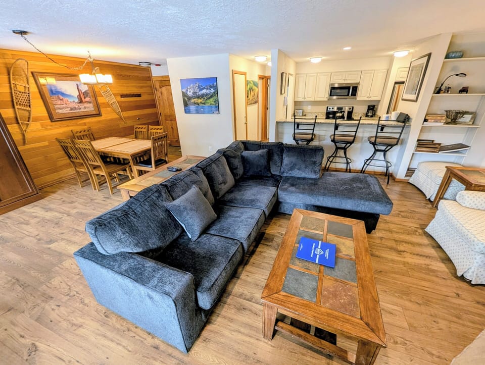 Sink into plush sectional seating where rustic wood meets modern comfort, your perfect spot to unwind after mountain adventures.
