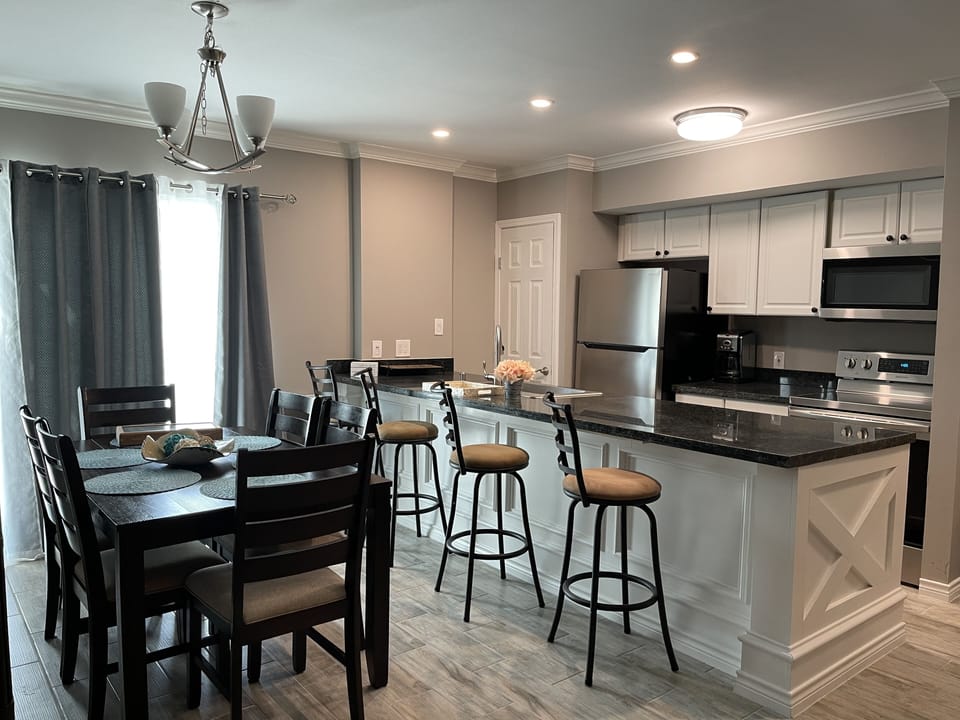 open kitchen area with counter top island and dining table.