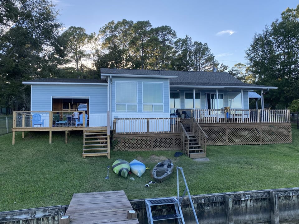 Back deck and game room with garage doors open