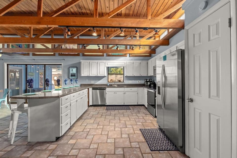 Spacious kitchen - fully-stocked & well-appointed for your stay. Stainless steel appliances and breakfast bar seats 6.