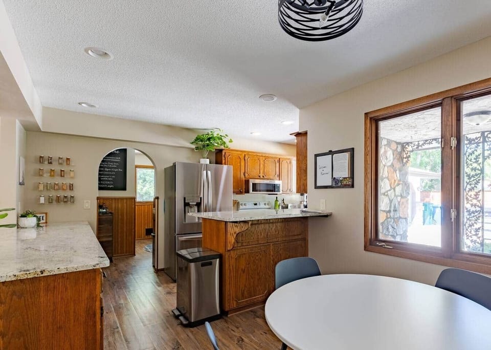 Stocked kitchen with cookware, place settings, utensils, spices and more for your stay.  Refrigerator with ice and water on the door and ice maker in the freezer. Induction stove.  In kitchen dining table with seats for four plus guests.  