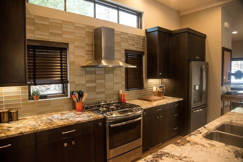 Modern stainless steel appliances, including a convenient double oven and wine fridge