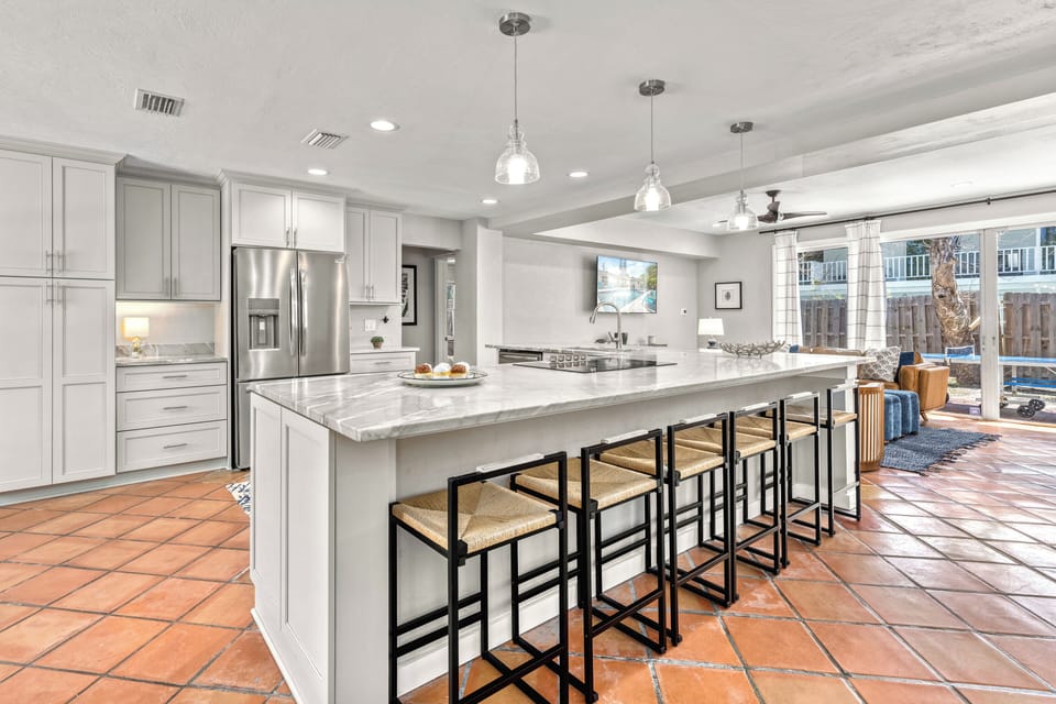 The kitchen island with breakfast bar seats six—perfect for casual dining or morning planning.