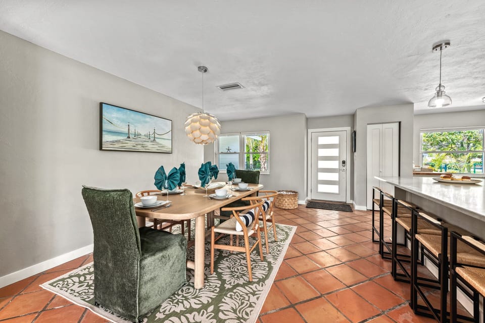 Coastal artwork and soft lighting frame your dining experience with a casual, island-inspired vibe.