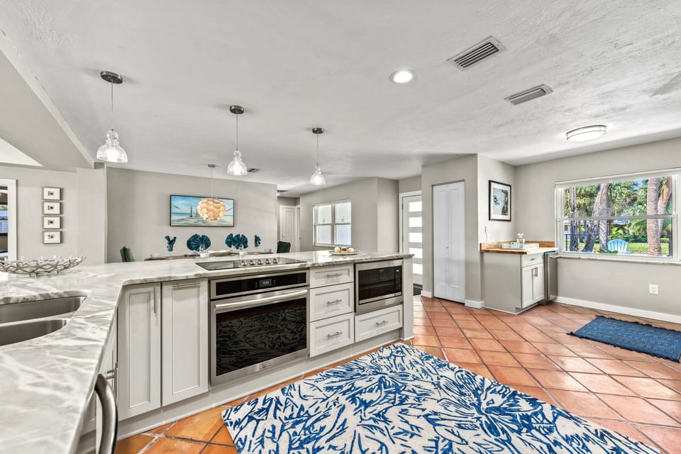 Stainless appliances and bright cabinetry keep the space fresh and functional for home-cooked meals.