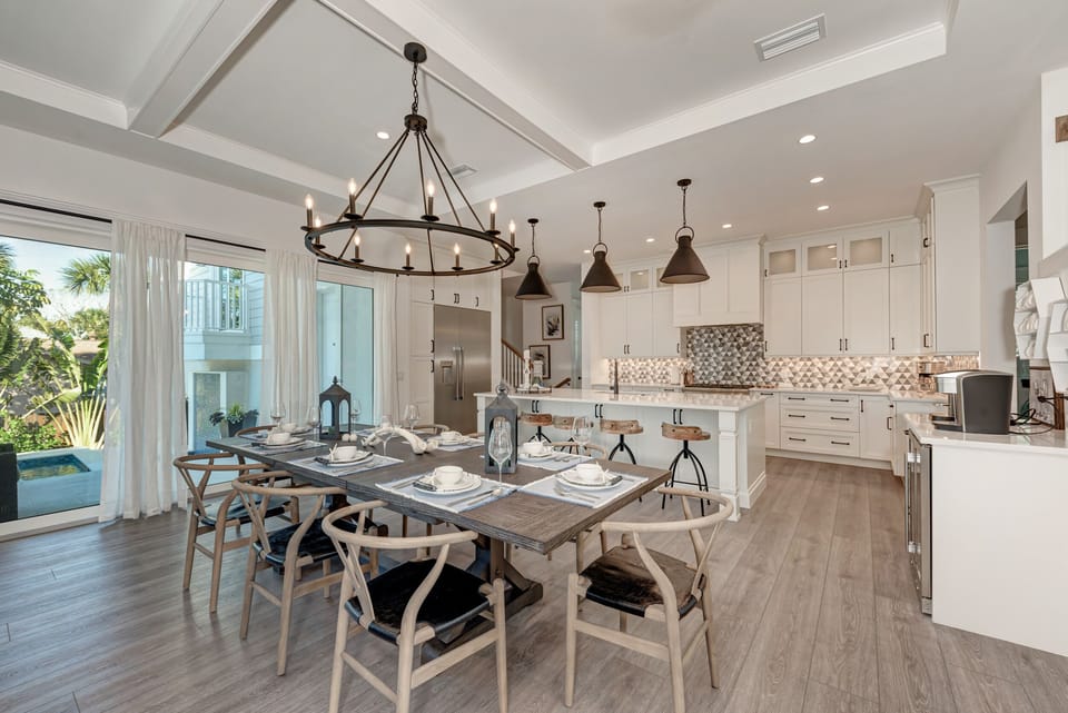 Oversized dining room table boasts seating for 8, kitchen island adds an additional 5 seats