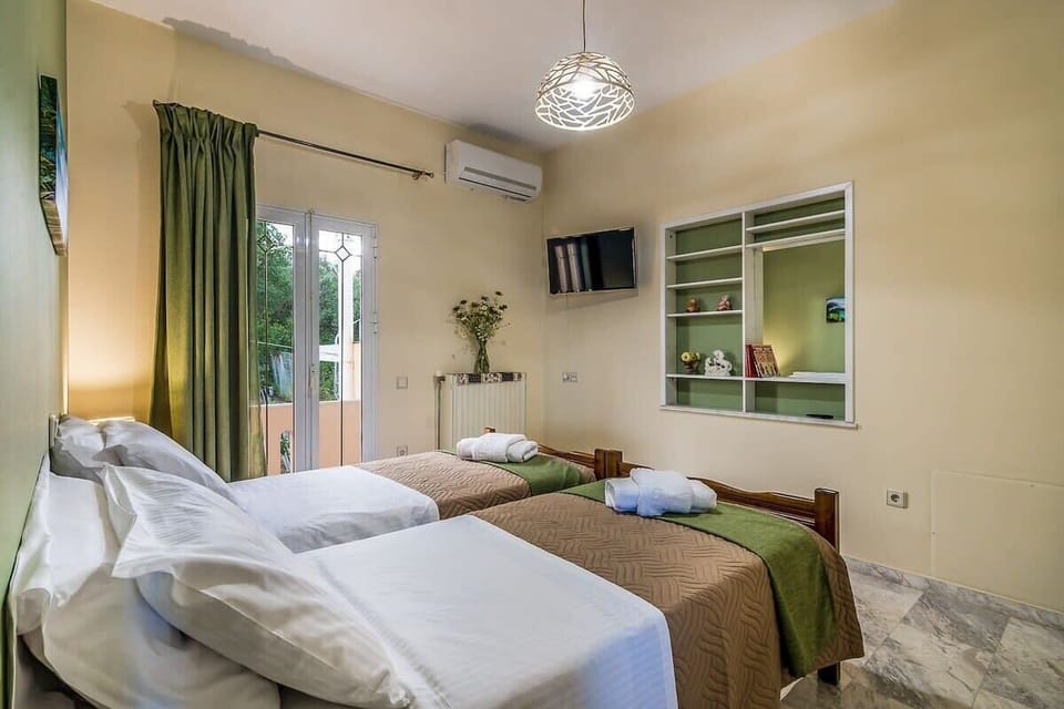 Bedroom 2 with Natural Light and Garden View – Bright twin bedroom with soft tones, natural light, and calming outlooks.