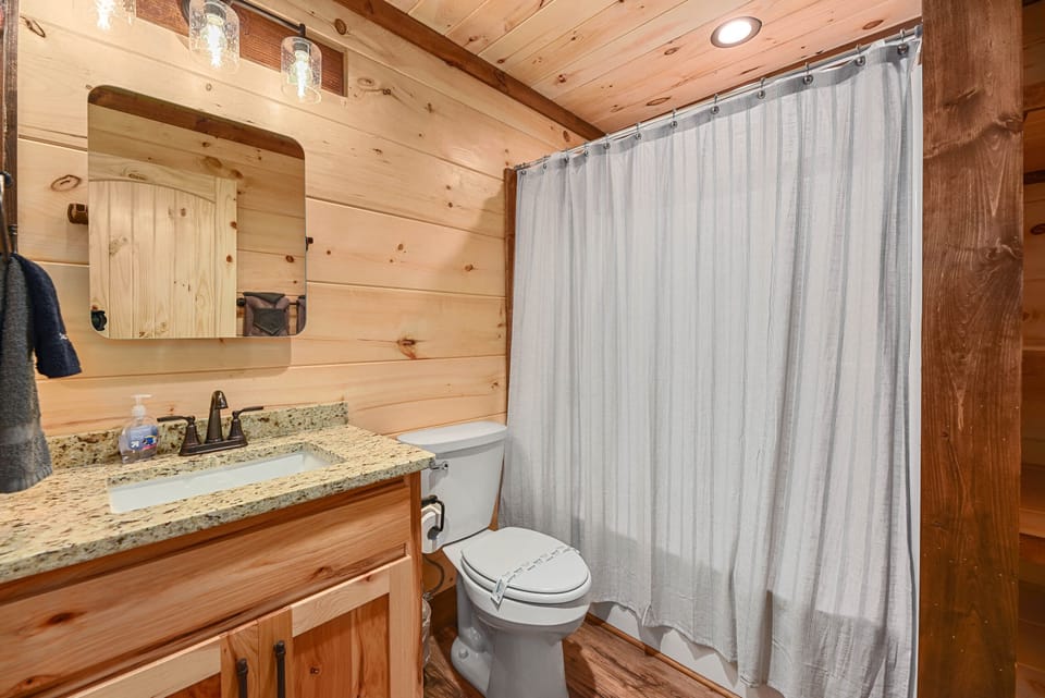 Lower level bathroom has a shower + tub as well as a baby bath