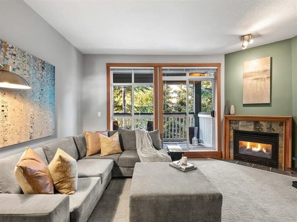 Living room with gas fireplace and large patio and queen Murphy bed