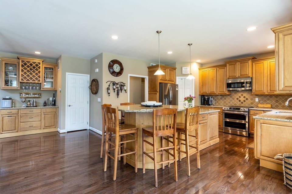 The kitchen has breakfast bar that seats and a wet bar for entertaining.