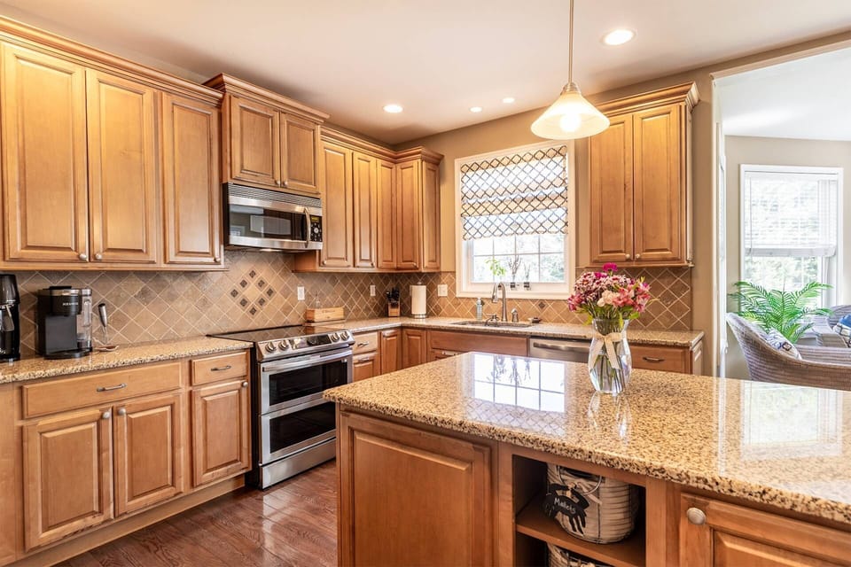The kitchen is fully stocked with cookware, serving ware, dining ware and bar ware to host a large family gathering.