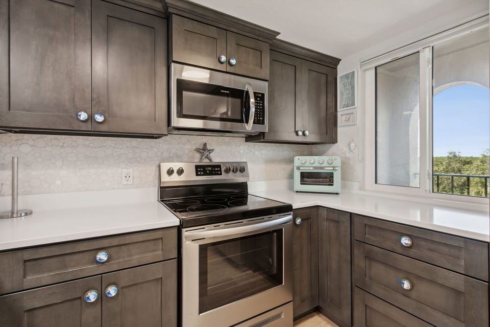 Totally Remodeled and Fully Equipped Kitchen with Stainless Steel Appliances, Beautiful Cabinetry, and Stunning Granite Countertops