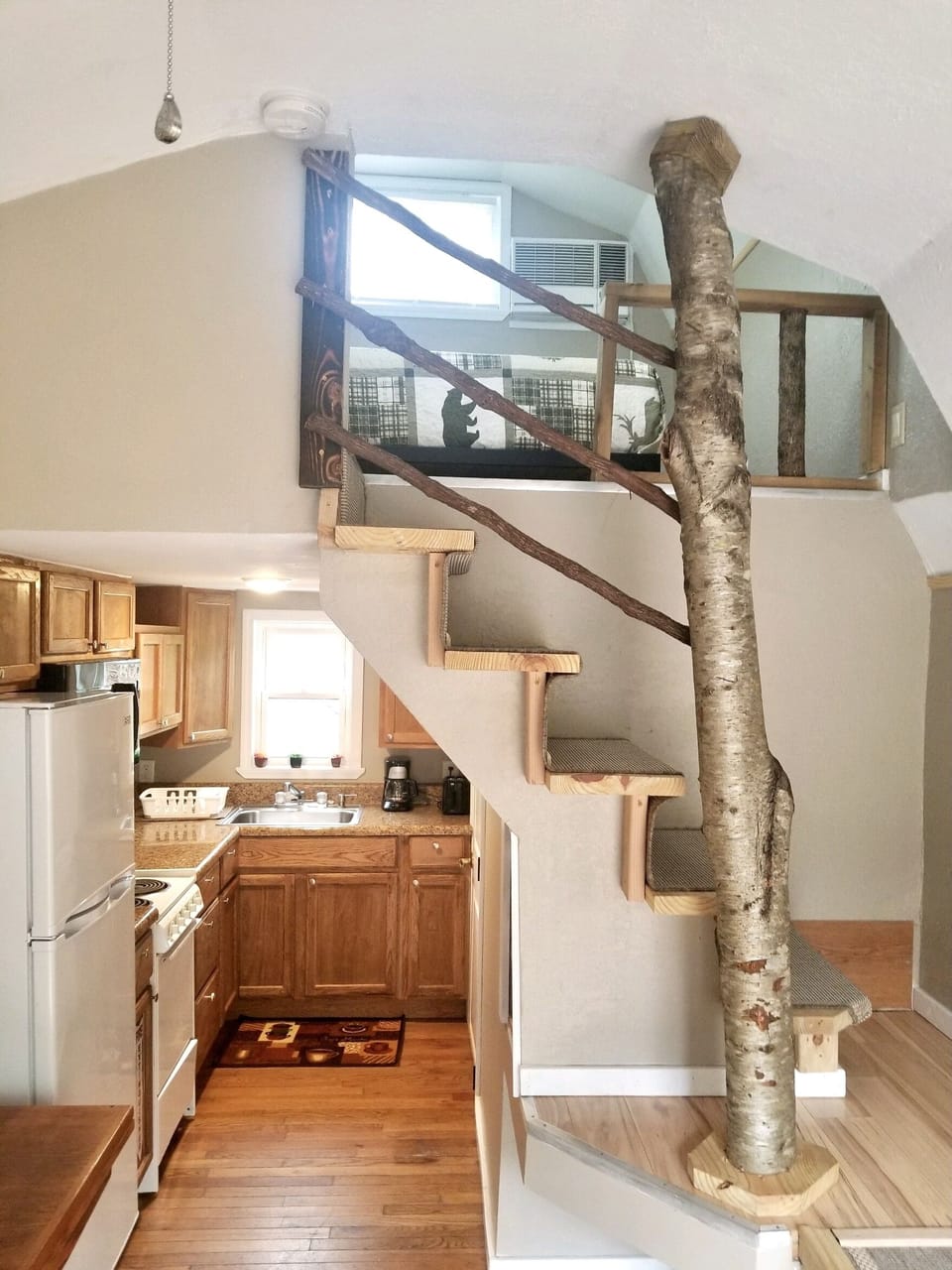 entry view of upstairs and full kitchen