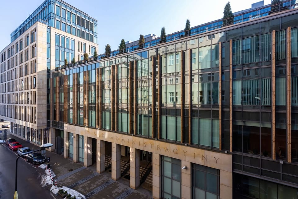 An exterior shot of a city building with modern architecture and large windows.