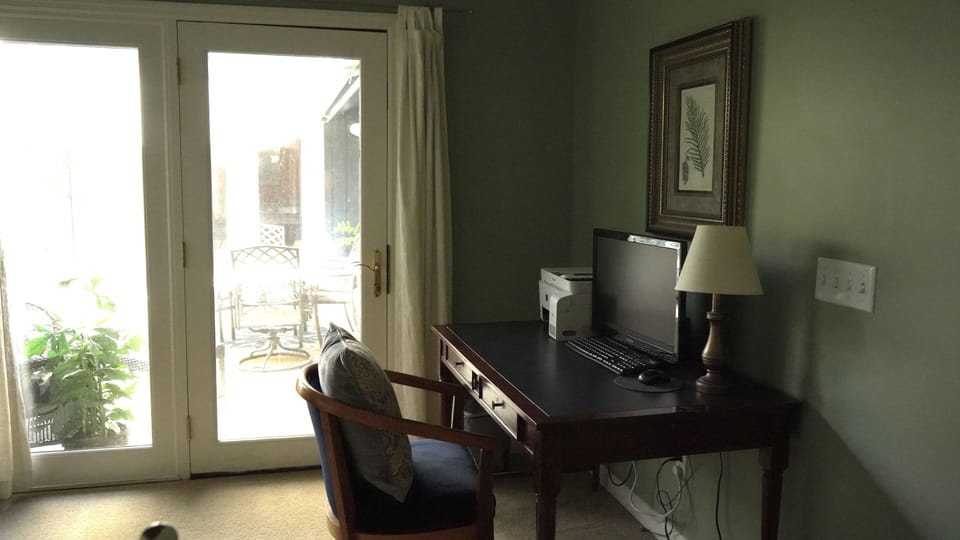 Master bedroom offers a desk with monitor and printer.
