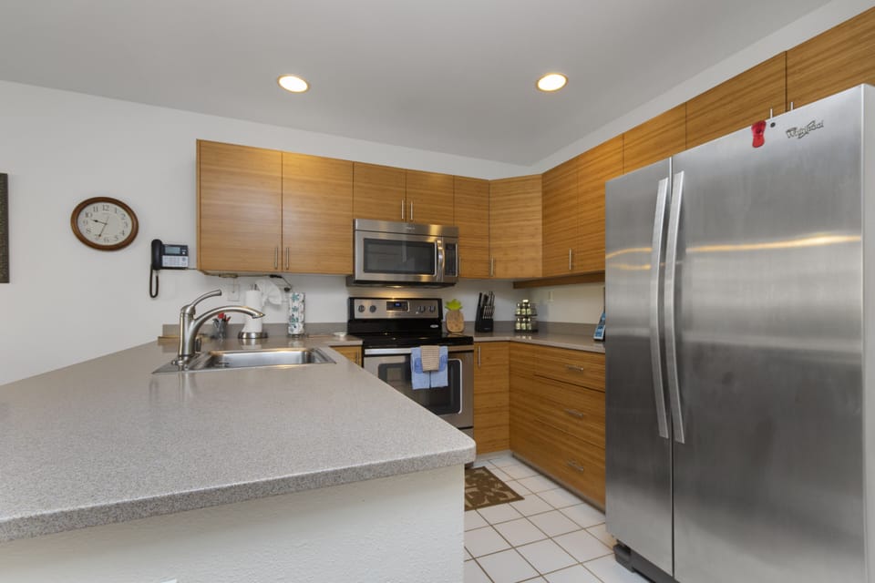 Your fully equipped kitchen features modern appliances, warm wood cabinetry, and generous counter space—perfect for preparing meals and enjoying the comforts of home during your stay.