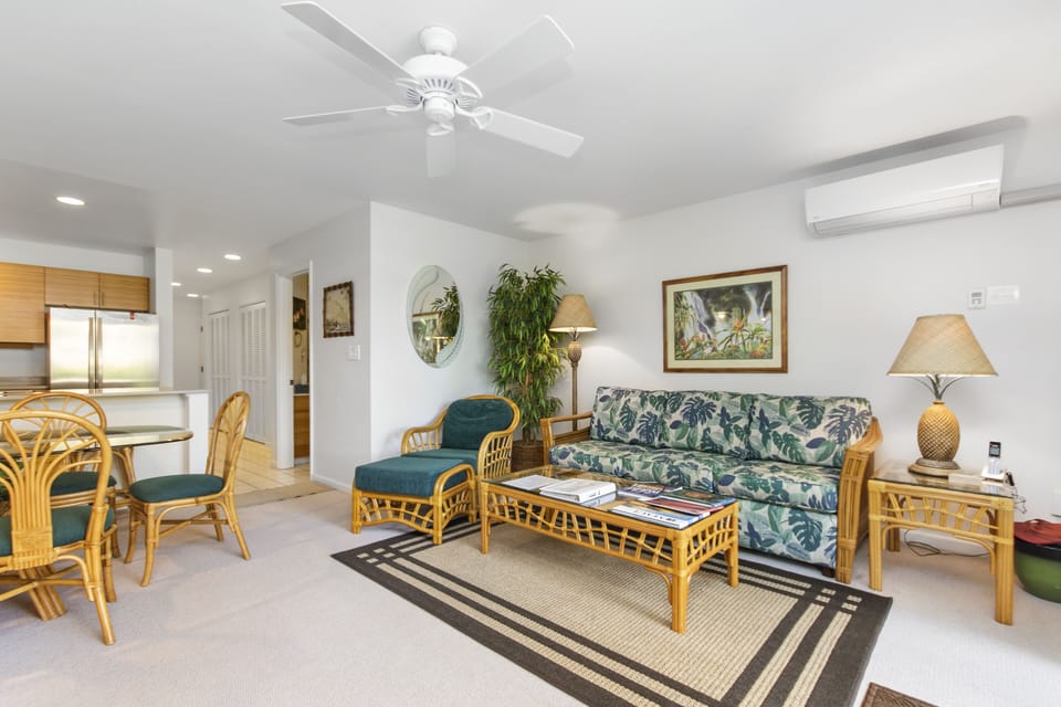 Relax in your bright, island-inspired living space with comfortable rattan seating, tropical accents, and breezy overhead fans—perfect for unwinding after a day of adventure.