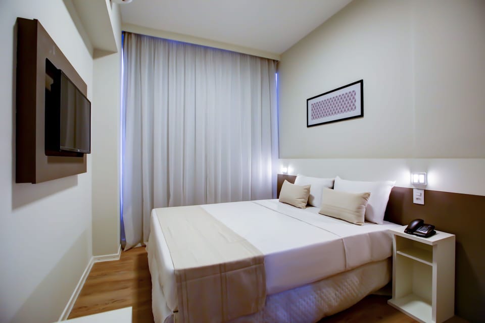 Standard Double Room | Minibar, in-room safe, blackout drapes, iron/ironing board