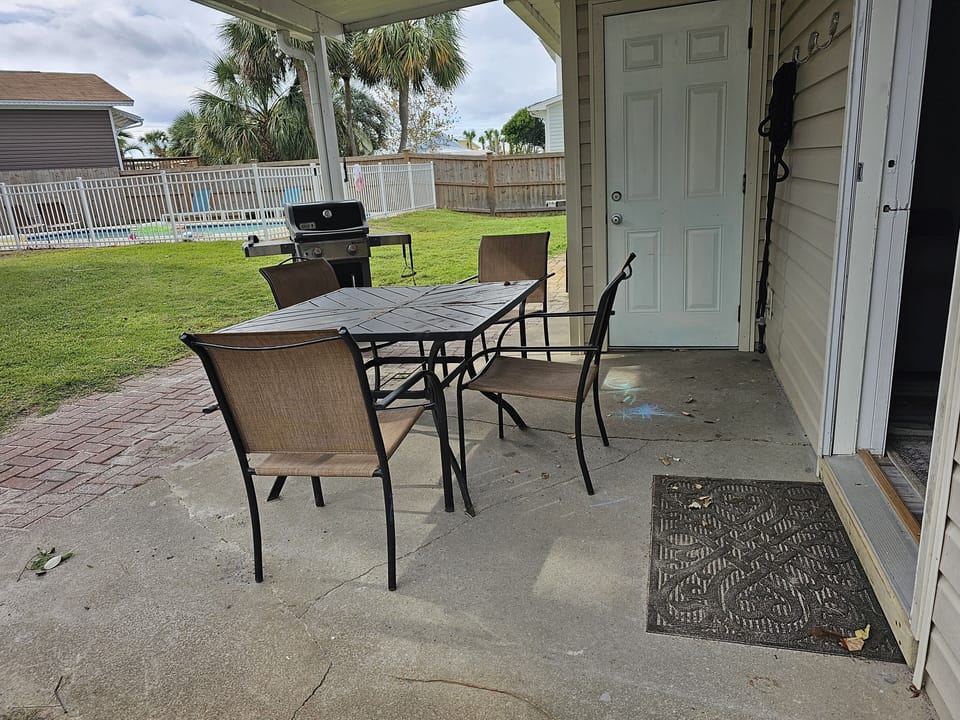 private patio with bbq grill facing the pool