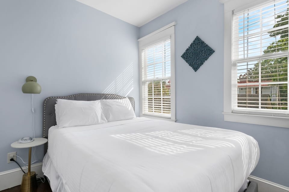 Wake up to sunshine and the peaceful view of swaying trees from bed.