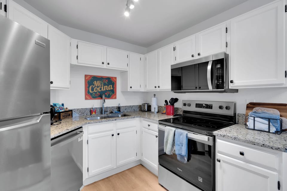 Modern kitchen with granite counters, stainless appliances, and Southwest flair