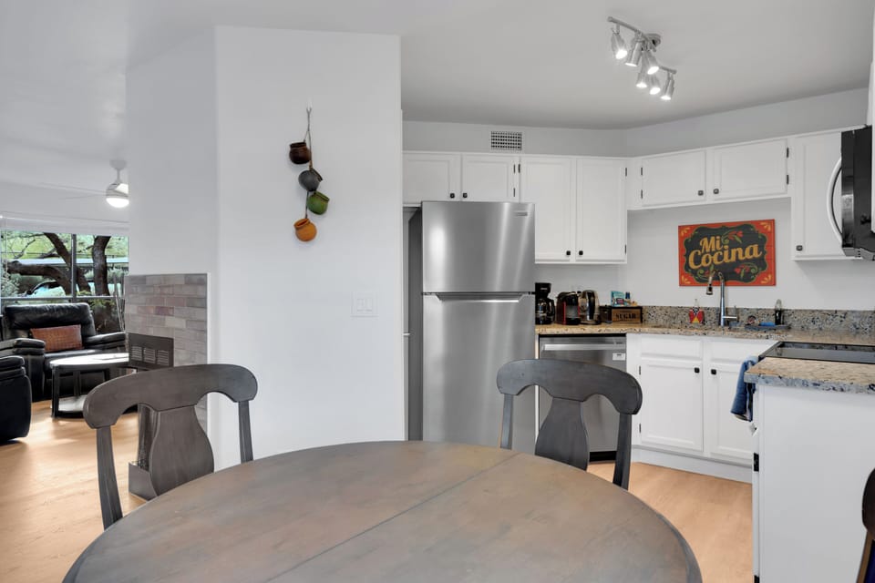 Open kitchen and dining area with stainless appliances and Southwest charm