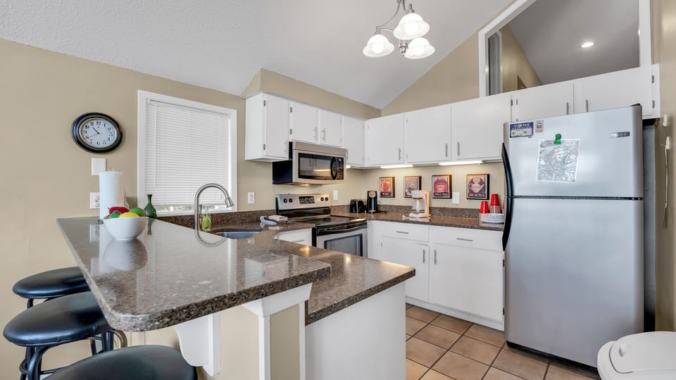 Main kitchen area that is stocked with everything you need to cook and eat with