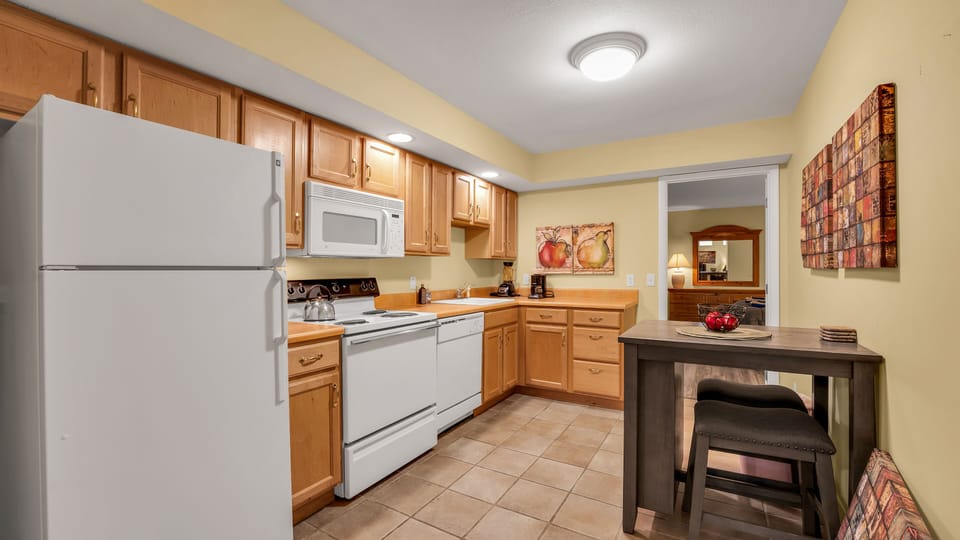 The basement kitchen is stocked with everything you need to cook and eat with.