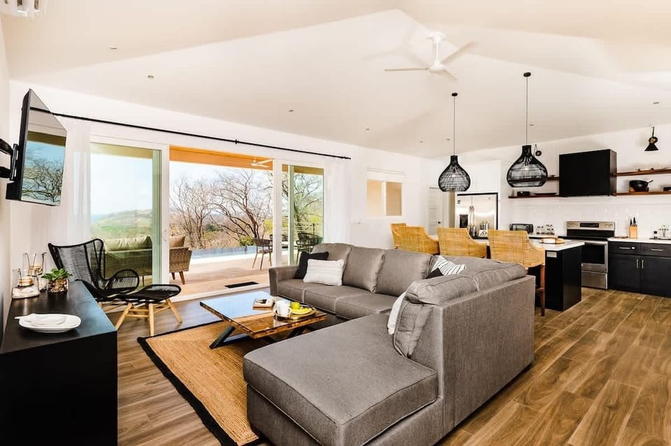 Spacious living area, kitchen and access to pool