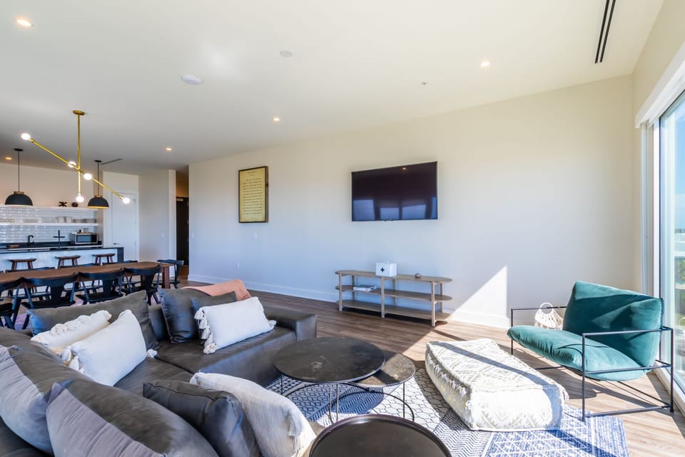 Living room with a luxurious leather couch, TV and views from every angle of the room.