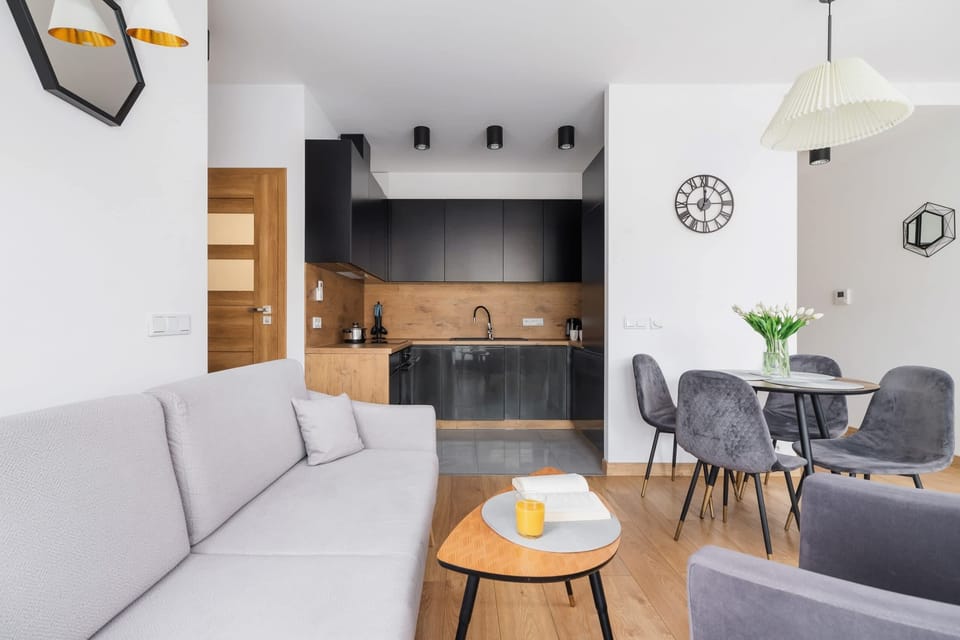 The elegant living room featuring a double sofa bed, perfect for relaxing or sleeping.