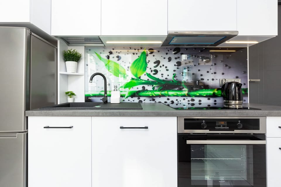 Bright green accents in the kitchenette add a playful touch to the space.
