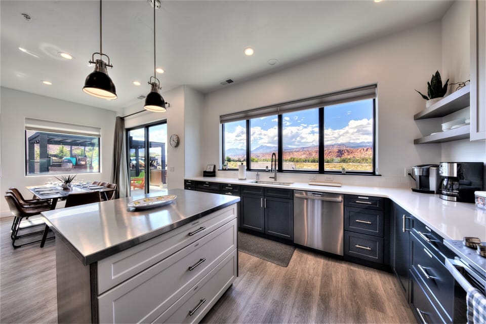 Large open kitchen with stainless steel island showing the beautiful views.