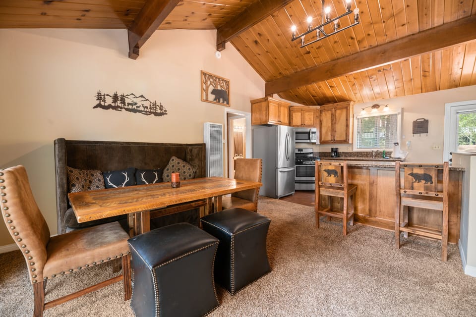 Dining Room. Vaulted Ceilings and Lake view - Bar at kitchen as well as table with cushioned chairs and a fireplace!
Patio with more, outdoor seating right outside the Dining Room.