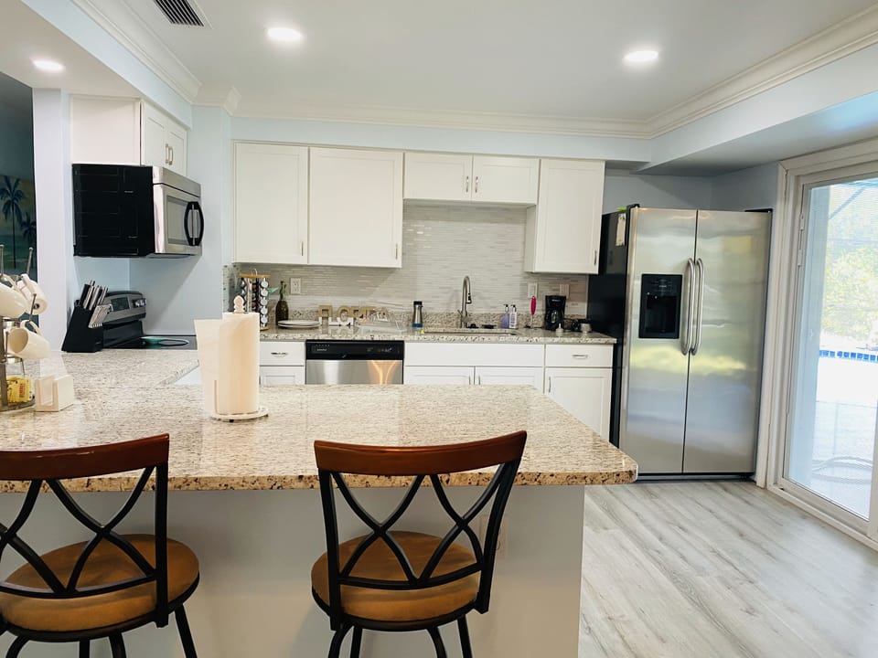 Kitchen counter with full view of pool area.
