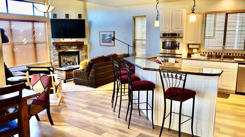 Large open great room with a fully stocked up to date kitchen and large table