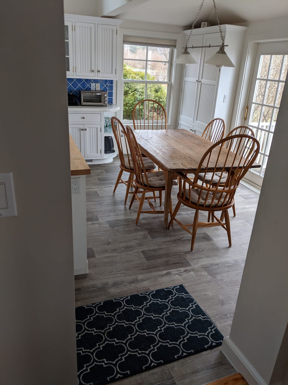 Kitchen eating area with door to side deck and grill