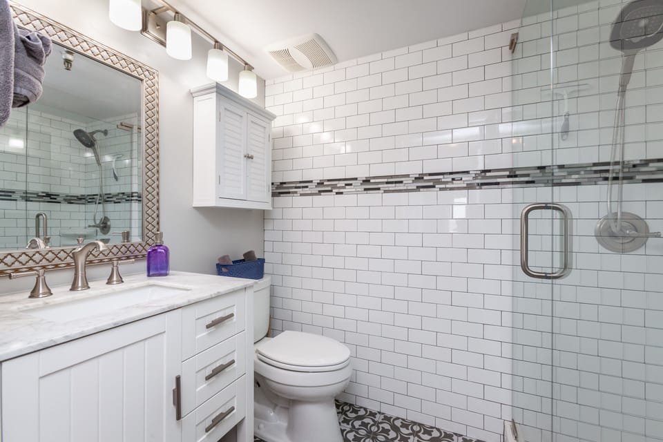 Primary bathroom. Subway tile. Marble topped vanity. Walk-in shower. 