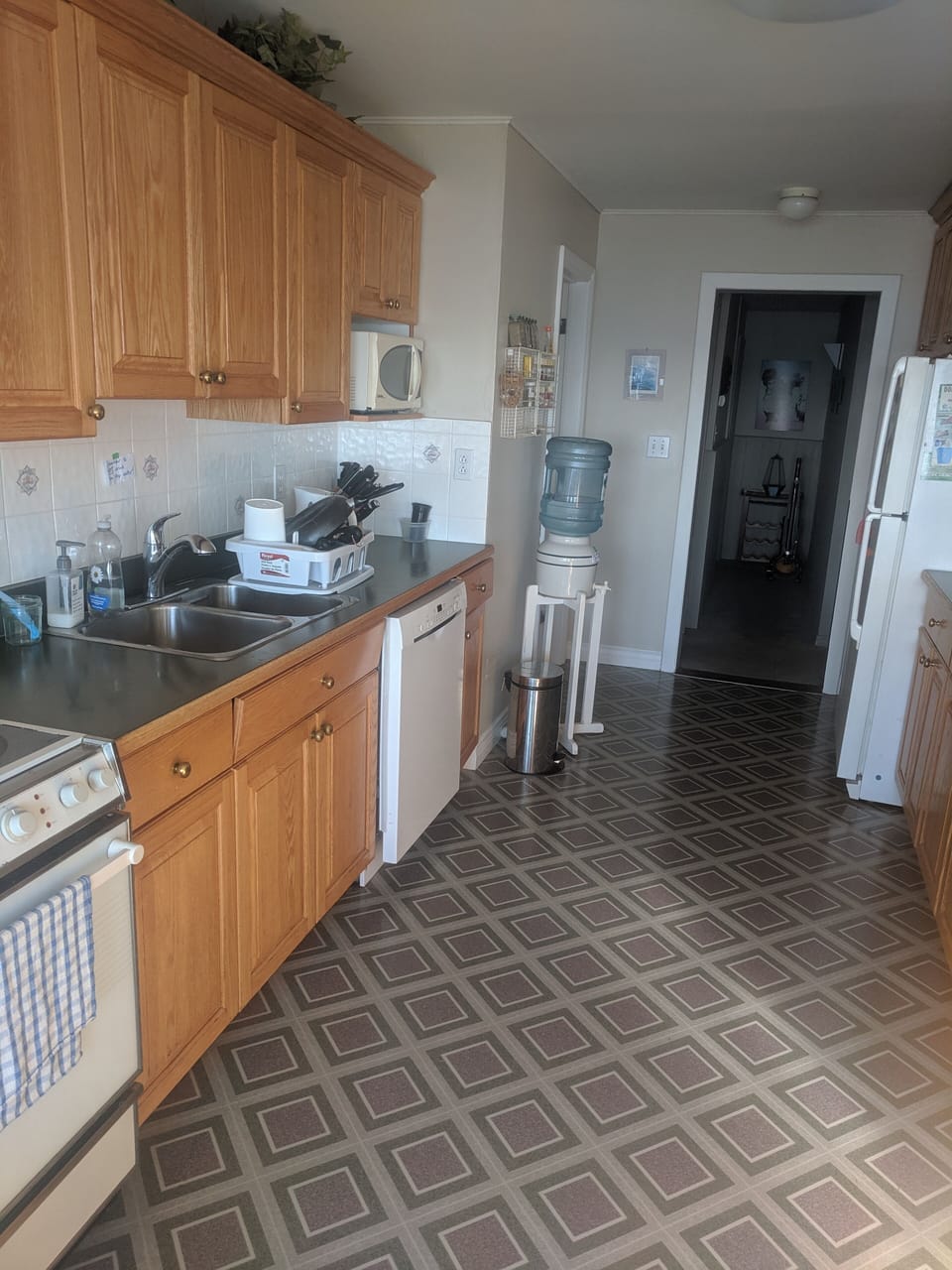 Kitchen with fridge, stove, oven, dishwasher, microwave.
