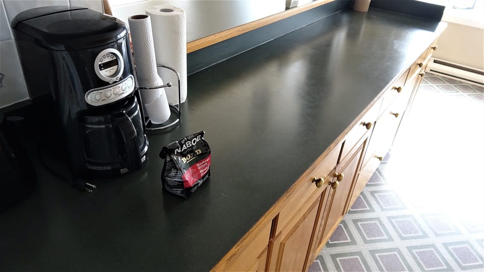 Long countertop island in kitchen