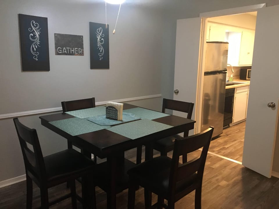 Counter height table with ceiling fan above to enjoy meals and entertain.