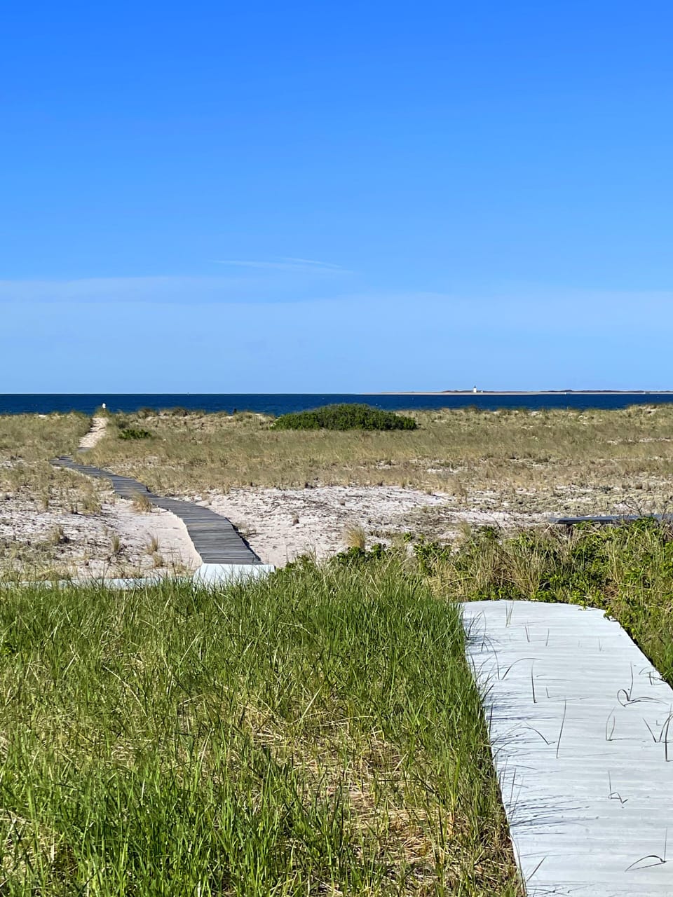 A boardwalk meanders to our private beach from Pipers' Shore Driftwood Cottage.