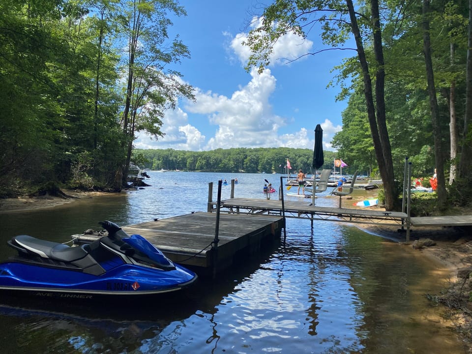 Summer view of our boat dock on the property (jetski not included in rental)