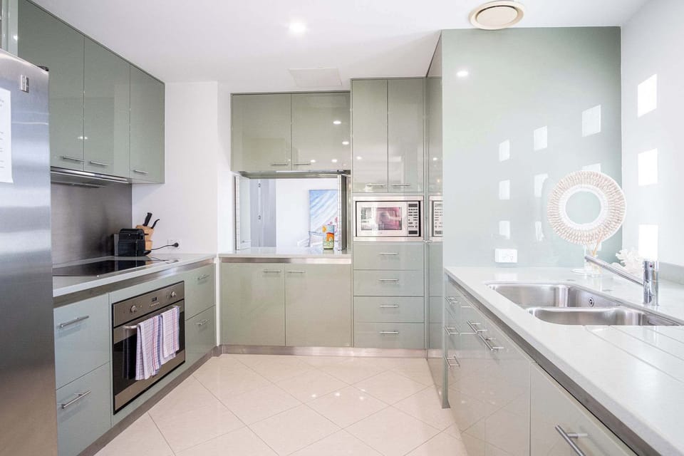 Modern kitchen with sage green cabinetry.